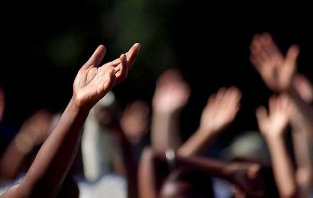 Hands rise up in prayer 