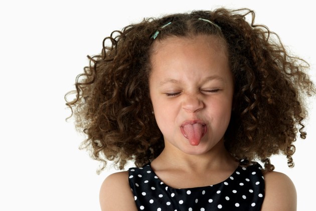 Girl Sticking Out Tongue --- Image by © Royalty-Free/Corbis